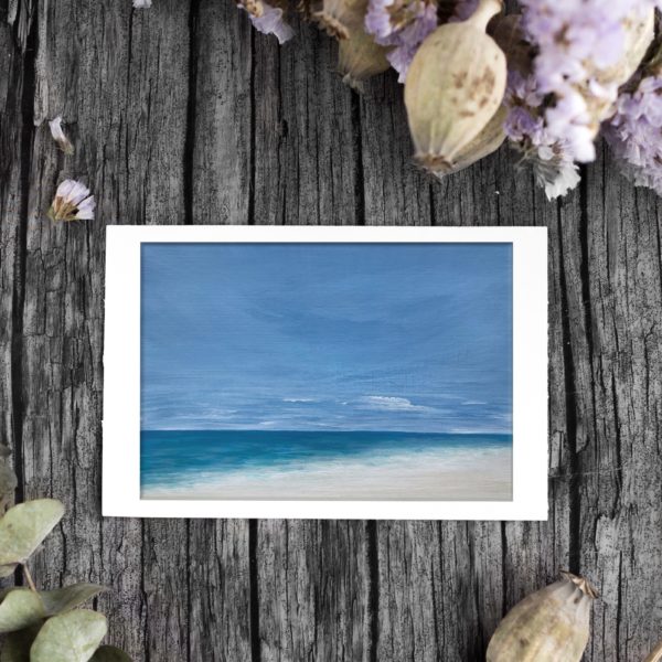 Beach painting with cloudy sky with flowers on a wooden background