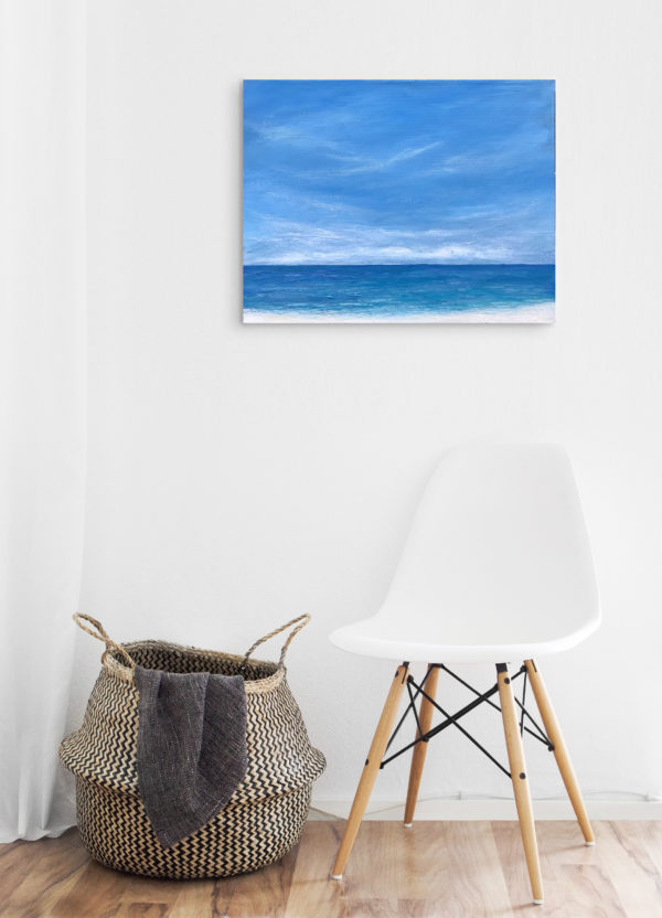 tropical beach painting in white room with chair
